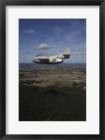 Framed Saab J 29 jet fighter flying over landscape