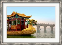 Framed Summer Palace, a traditional Dragon Boat passes the Seventeen Arch Bridge, Kunming lake, Beijing, China