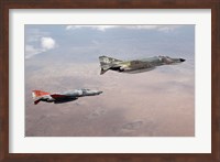 Framed Two QF-4E Phantom II drones in formation over the New Mexico desert