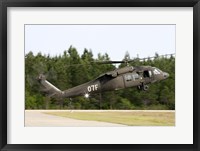 Framed US Army UH-60L Blackhawk helicopter landing at Florida Airport