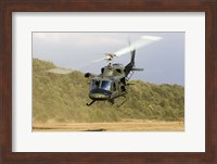 Framed Italian Air Force AB-212 ICO helicopter departs the landing zone, Italy