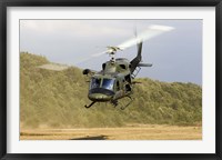 Framed Italian Air Force AB-212 ICO helicopter departs the landing zone, Italy