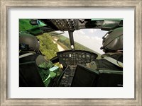 Framed Two instructor pilots practice low flying operations in a UH-1H Huey helicopter