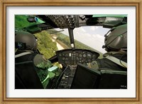 Framed Two instructor pilots practice low flying operations in a UH-1H Huey helicopter