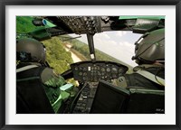 Framed Two instructor pilots practice low flying operations in a UH-1H Huey helicopter