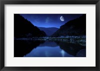 Framed Moon rising over tranquil lake and forest against starry sky, Bulgaria