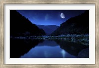 Framed Moon rising over tranquil lake and forest against starry sky, Bulgaria