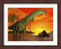 Framed Large Argentinosaurus dinosaur in water at sunset