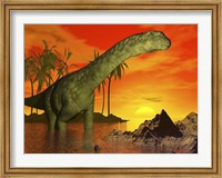 Framed Large Argentinosaurus dinosaur in water at sunset