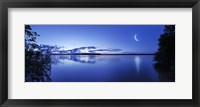 Framed Moon rising over tranquil lake against moody sky, Mozhaisk, Russia