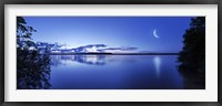 Framed Moon rising over tranquil lake against moody sky, Mozhaisk, Russia