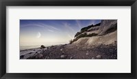 Framed Tranquil seaside and Mons Klint cliffs against rising moon, Denmark