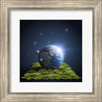 Framed Planet Earth lying on a green lawn with moon and stars