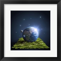 Framed Planet Earth lying on a green lawn with moon and stars