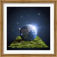 Framed Planet Earth lying on a green lawn with moon and stars