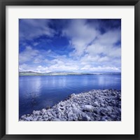 Framed Tranquil lake and rocky shore against cloudy sky, Sardinia, Italy