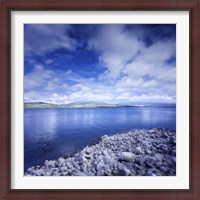 Framed Tranquil lake and rocky shore against cloudy sky, Sardinia, Italy