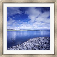 Framed Tranquil lake and rocky shore against cloudy sky, Sardinia, Italy