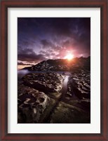Framed Rocky shore and tranquil sea against cloudy sky at sunset, Sardinia, Italy