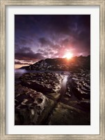 Framed Rocky shore and tranquil sea against cloudy sky at sunset, Sardinia, Italy