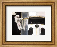 Framed Astronaut performs work on the Hubble Space Telescope
