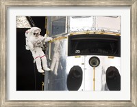 Framed Astronaut performs work on the Hubble Space Telescope