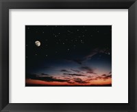 Framed Moon and stars in the sky at dusk