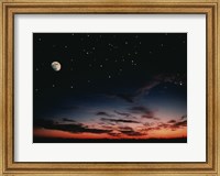 Framed Moon and stars in the sky at dusk