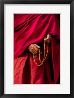 Framed Hands of a monk in red holding prayer beads, Leh, Ladakh, India