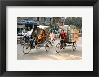 Framed People and cargo move through streets via rickshaw, Varanasi, India