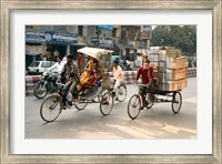 Framed People and cargo move through streets via rickshaw, Varanasi, India