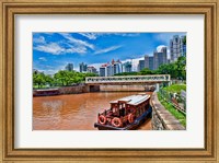 Framed Singapore skyline and tug boats on river.