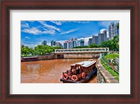 Framed Singapore skyline and tug boats on river.