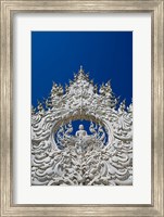 Framed new all white temple of Wat Rong Khun in Tambon Pa O Don Chai designed by Chalermchai Kositpipat.