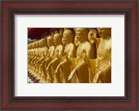 Framed Taiwan, Foukuangshan Temple, Standing gold-colored Buddha statues at a Buddhist shrine