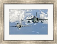 Framed Dassault Rafale of the French Air Force and an Embraer A-1B of the Brazilian Air Force