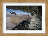 Framed Loadmaster on an HC-130 Watches a HH-60G Pave Hawk Refuel