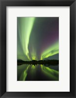 Framed Aurora borealis over Fish lake, Whitehorse, Yukon, Canada (vertical)