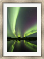Framed Aurora borealis over Fish lake, Whitehorse, Yukon, Canada (vertical)