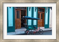 Framed Cuba, Camaquey, bike carriage and buildings