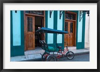 Framed Cuba, Camaquey, bike carriage and buildings