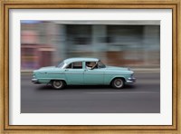 Framed 1950's era car in motion, Havana, Cuba