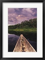 Framed Paddling a dugout canoe on Lake Anangucocha, Yasuni National Park, Amazon basin, Ecuador