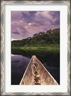 Framed Paddling a dugout canoe on Lake Anangucocha, Yasuni National Park, Amazon basin, Ecuador