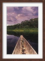 Framed Paddling a dugout canoe on Lake Anangucocha, Yasuni National Park, Amazon basin, Ecuador