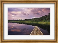 Framed Paddling a dugout canoe, Amazon basin, Ecuador