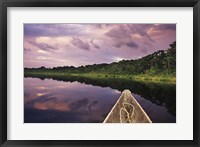 Framed Paddling a dugout canoe, Amazon basin, Ecuador