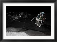Framed Two Manned Maneuvering Vehicles explore the airless, microgravity environment of a small asteroid