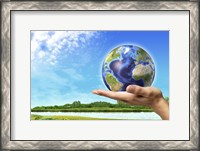 Framed Human Hand Holding Earth Globe with a Green Landscape Background