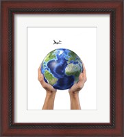 Framed Man's Hands Holding the Planet Earth, with a Jet Aircraft Flying Above